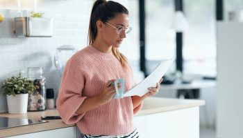 woman reading agreement in office kitchen
