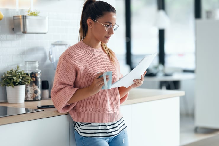 woman reading agreement in office kitchen